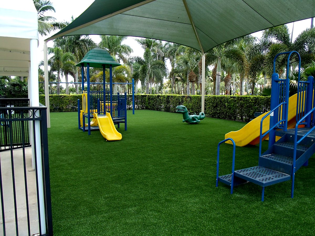 Shaded playground with synthetic turf surface