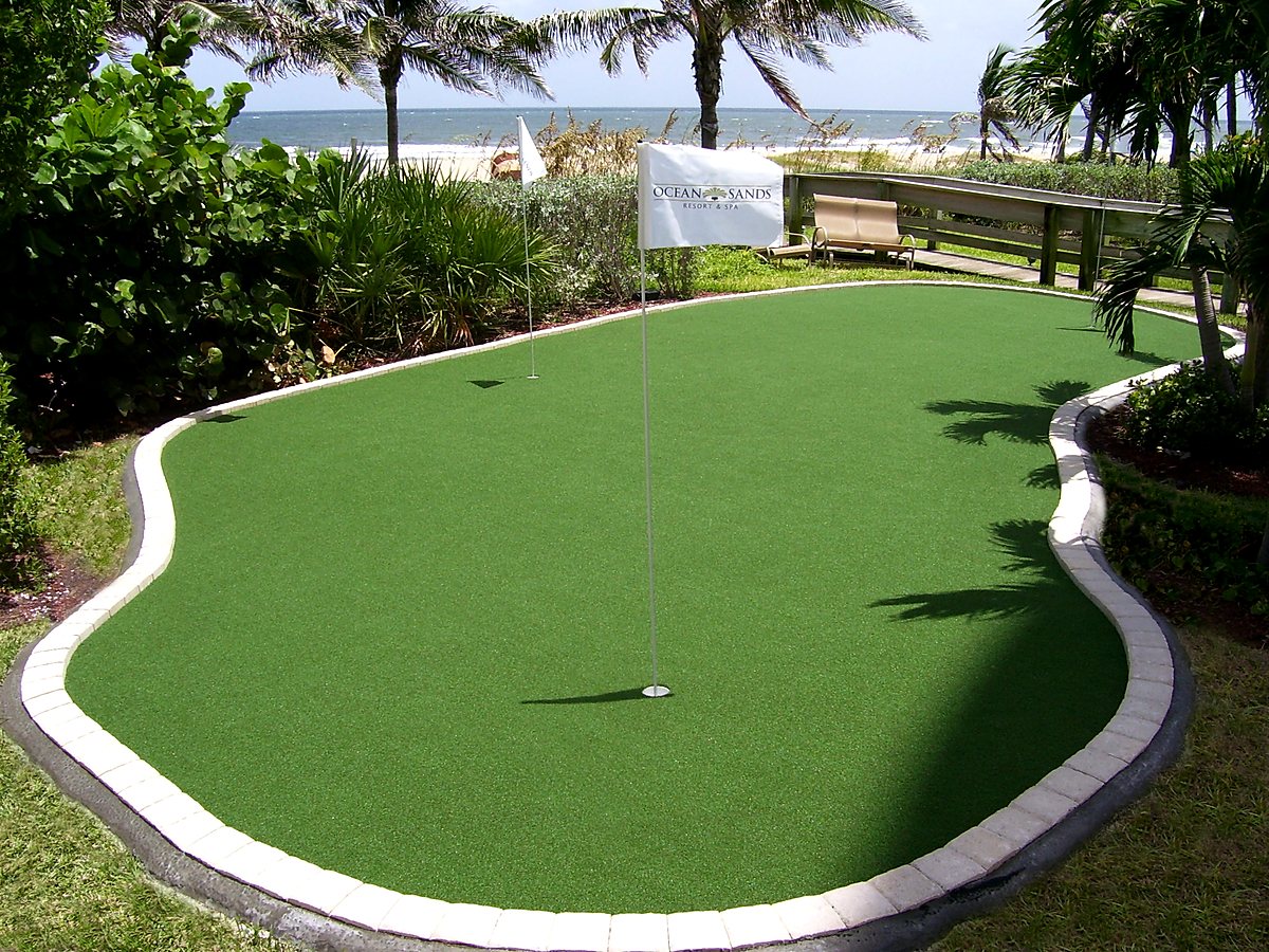 Curved putting green with paver border by the beach